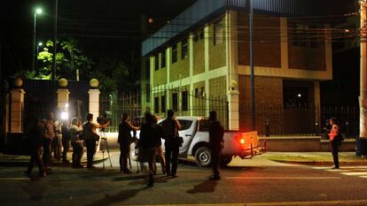 Reporters wait outside police headquarters in San Salvador.