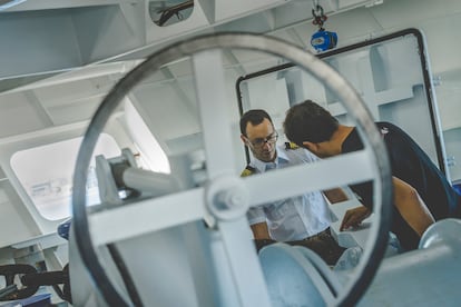 The captain of the 'Odón de Buen' – Adrián Gerpe – speaks with another member of the crew.