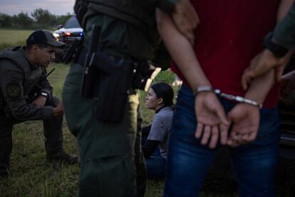 Texas state agents detain migrants who crossed the border on June 13 in Mission.