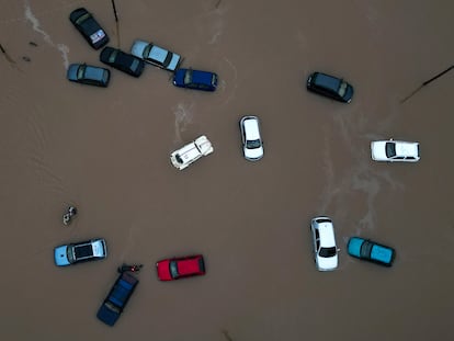 Oil and hydrocarbon stains come off vehicles affected by floods in Eldorado do Sul.