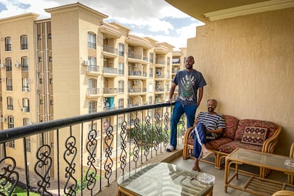 Nageeb Khalifa and his son Ashraf rest on the balcony of their spacious apartment in Al Rehab, the "New Cairo".